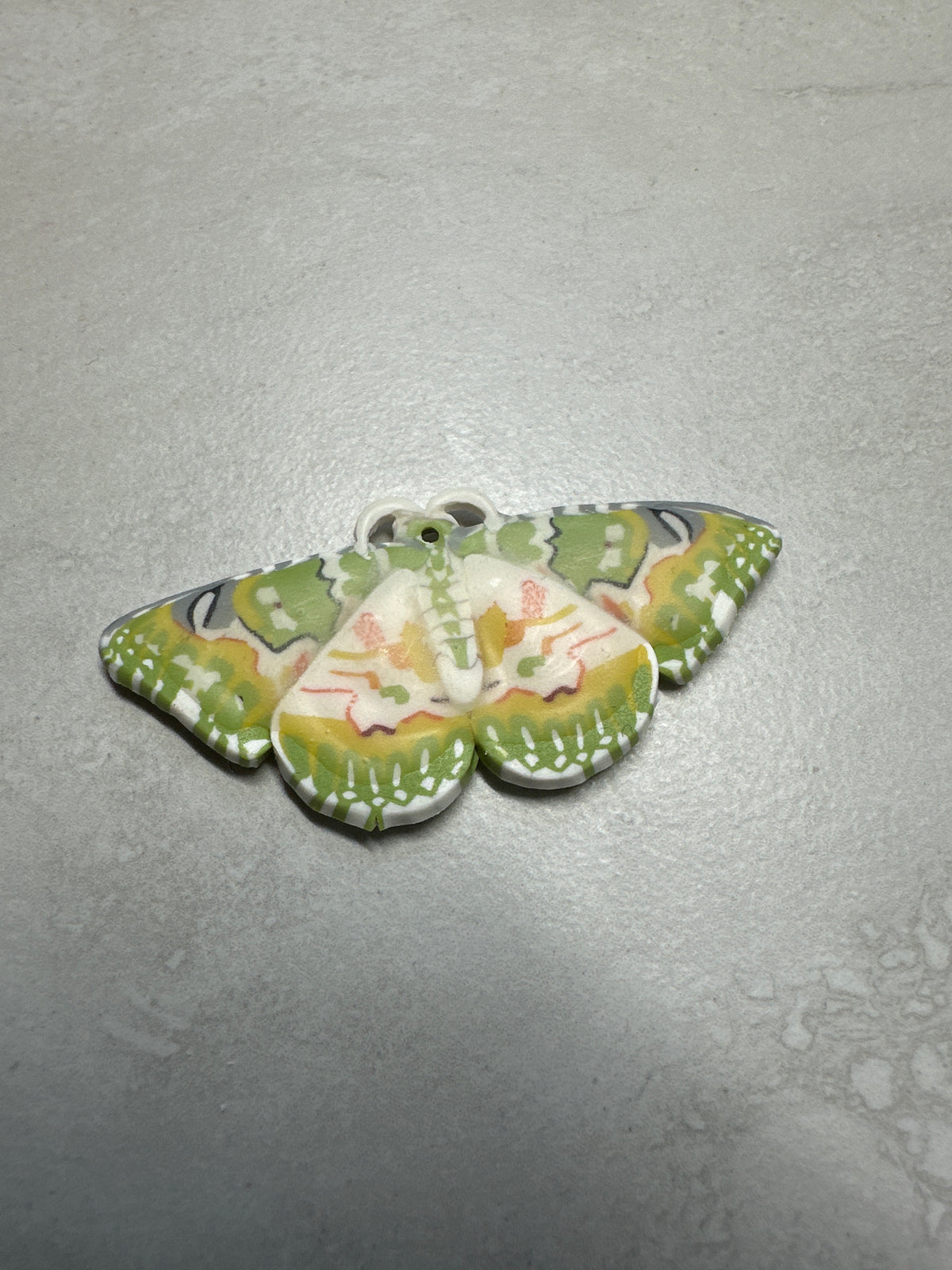 Oriental orange-banded green geometer moth and moon dangles