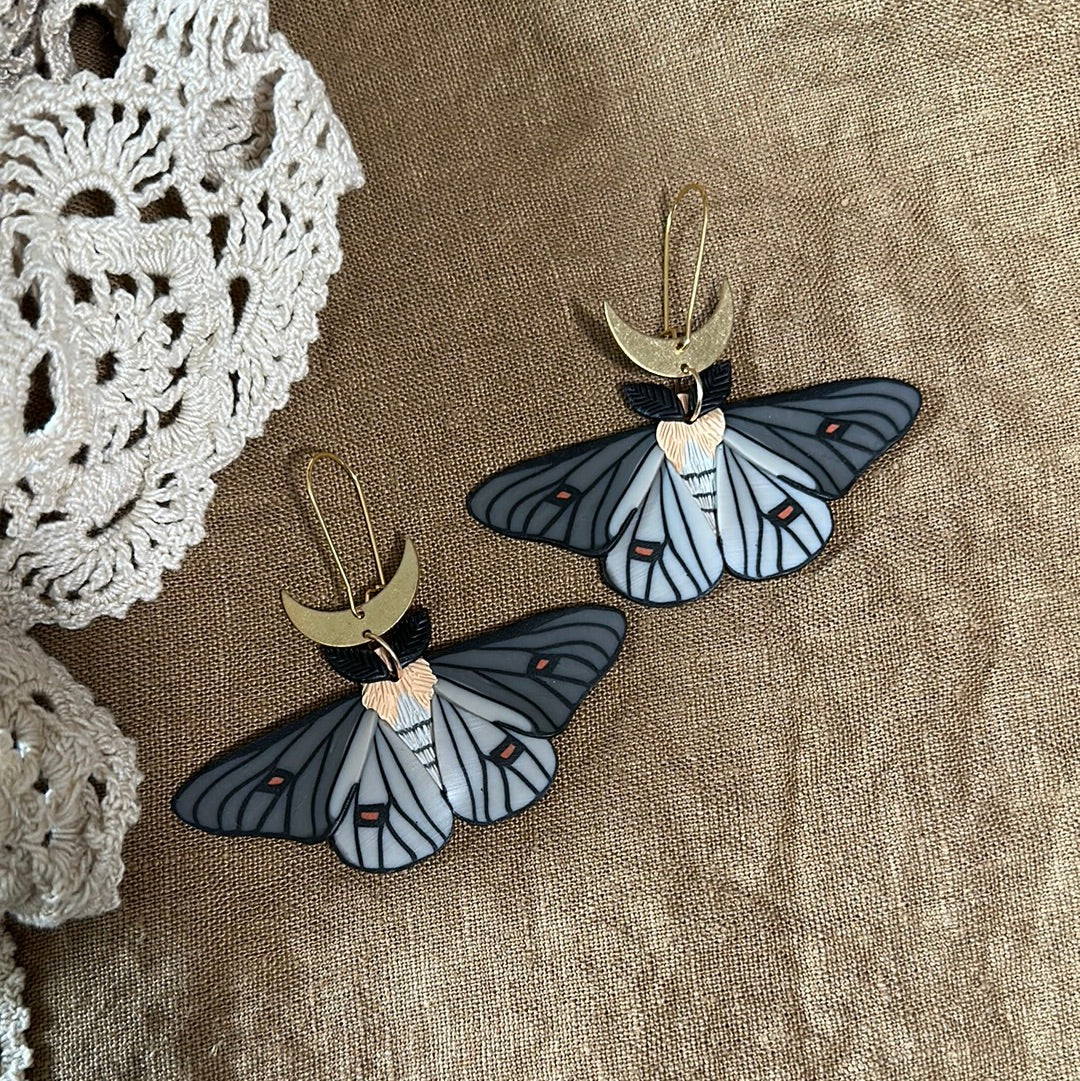 Ghostly silkmoth dangles