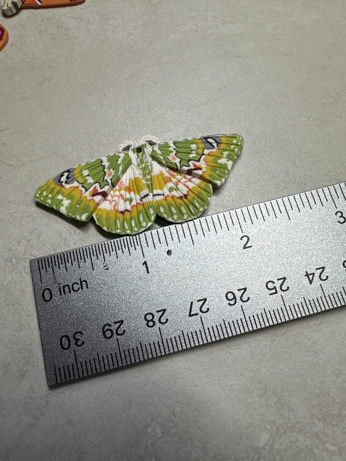 Oriental orange-banded green geometer moth and moon dangles