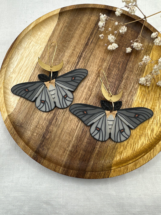 Ghostly silkmoth dangles