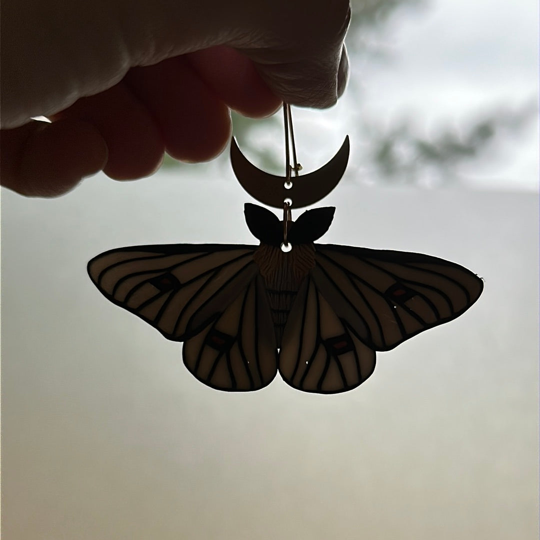 Ghostly silkmoth dangles